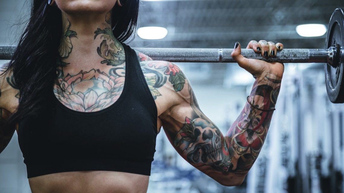 woman carrying barbell