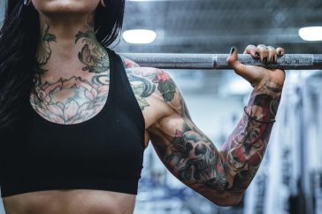 woman carrying barbell