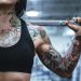 woman carrying barbell